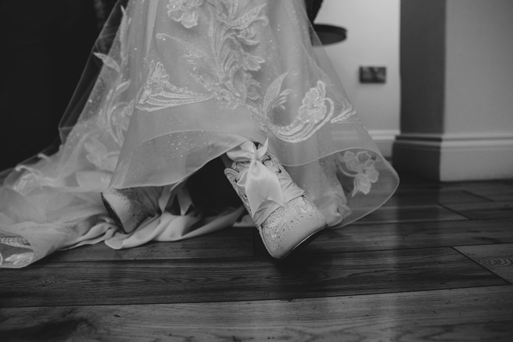 close up of brides lace boots under her dress