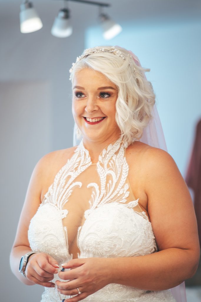 bride smiles at her reflection