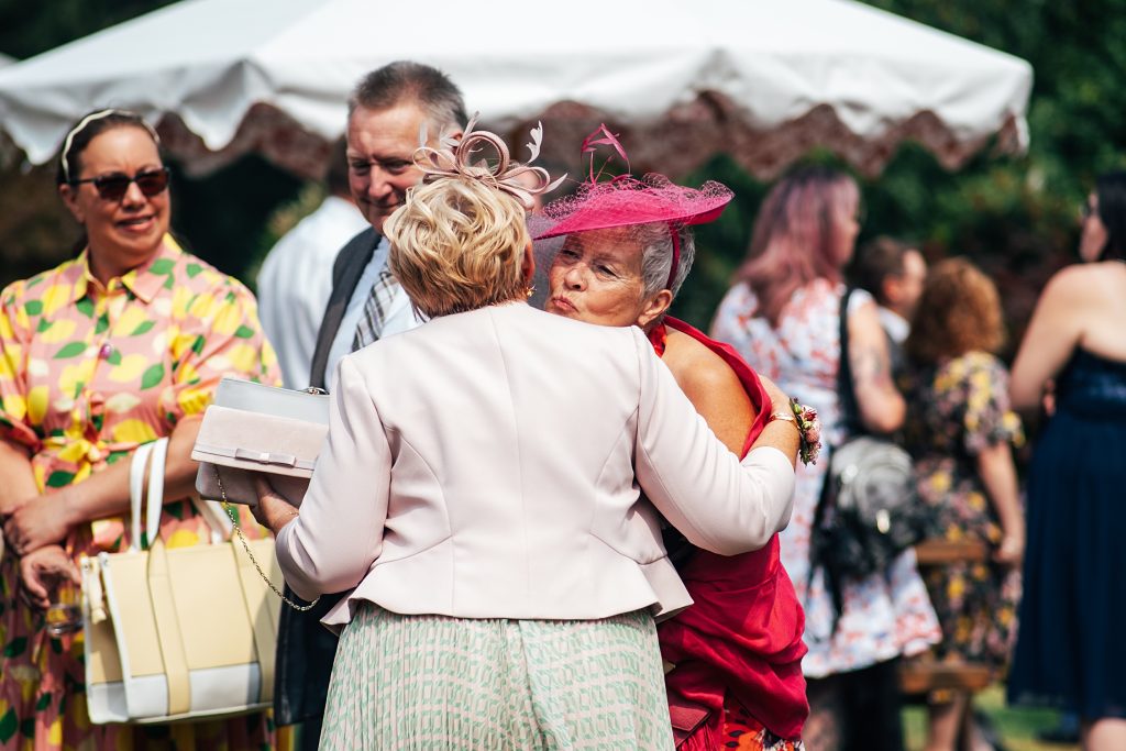 guests kiss as they greet