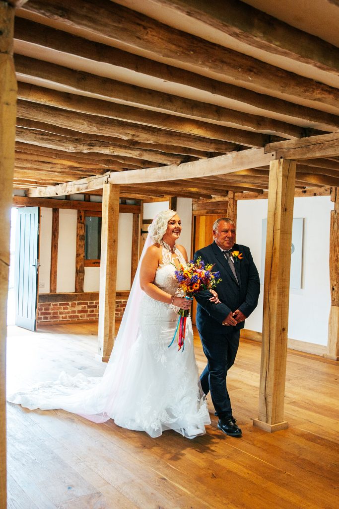 Bride walks down the aisle with her dad