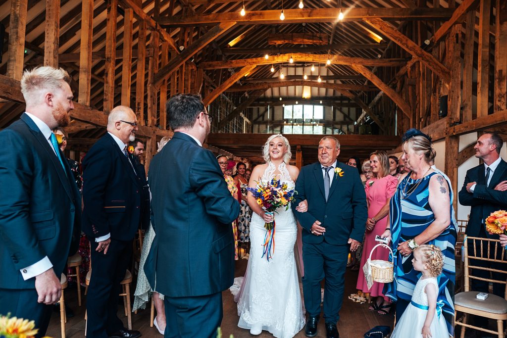 Bride walks down aisle with her dad