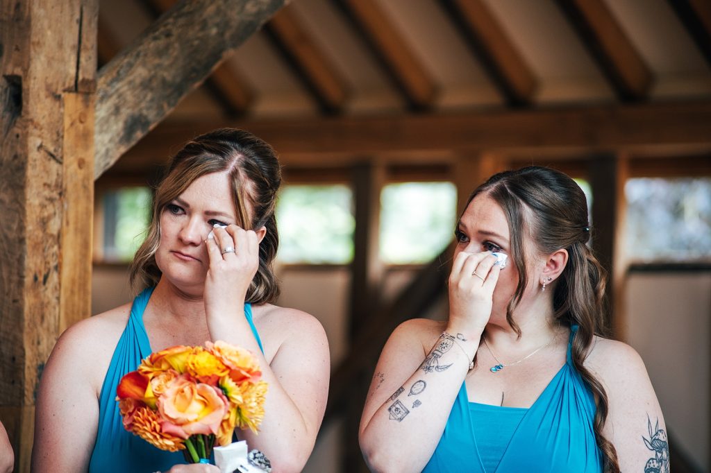 bridesmaids wipe tears away during ceremony