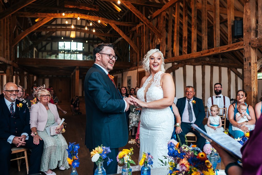 bride and groom laugh during ceremony