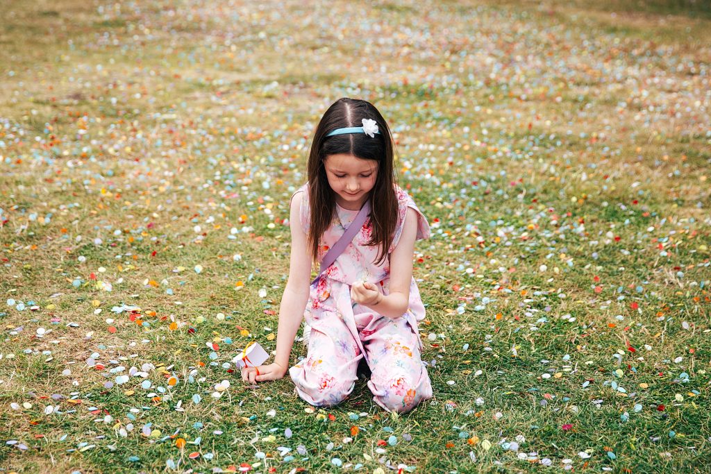 little girl picks up confetti