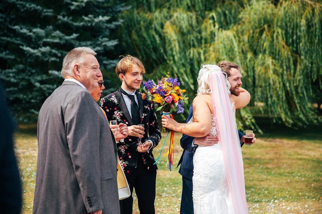 guests hug bride