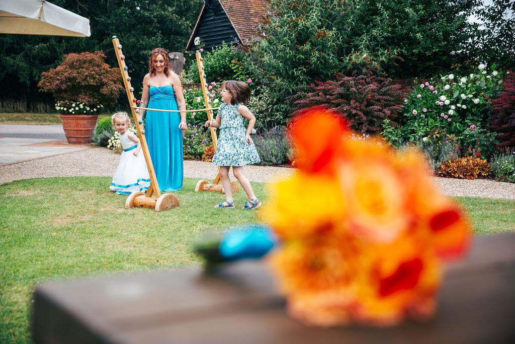 bridesmaid plays limbo with two little girls