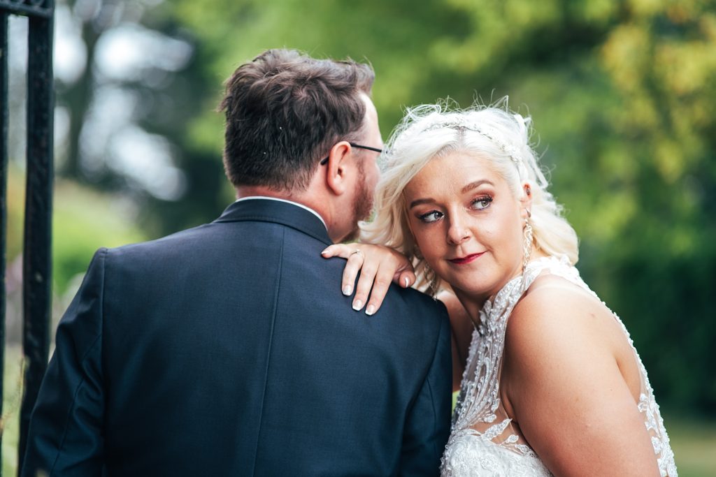 bride leans on grooms shoulder