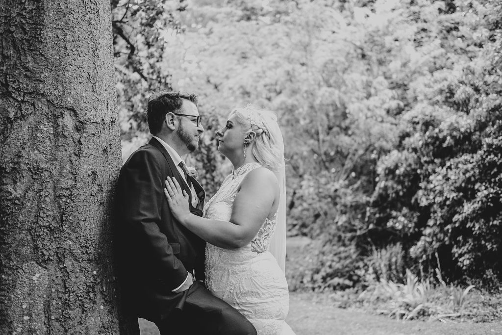 bride and groom by a tree in garden