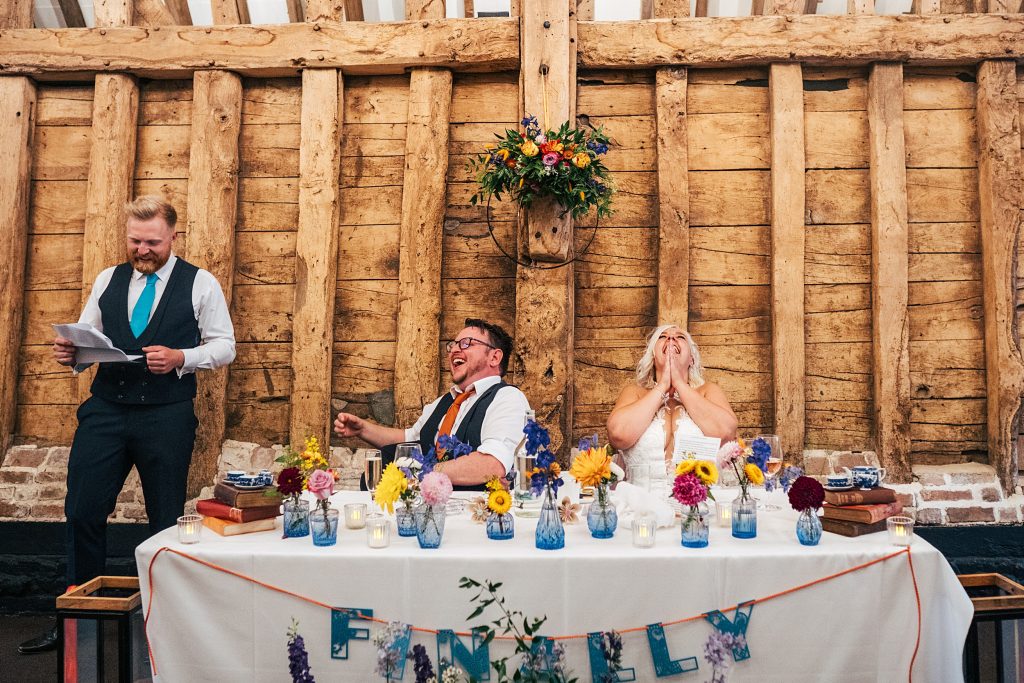 bride and groom laugh at speeches