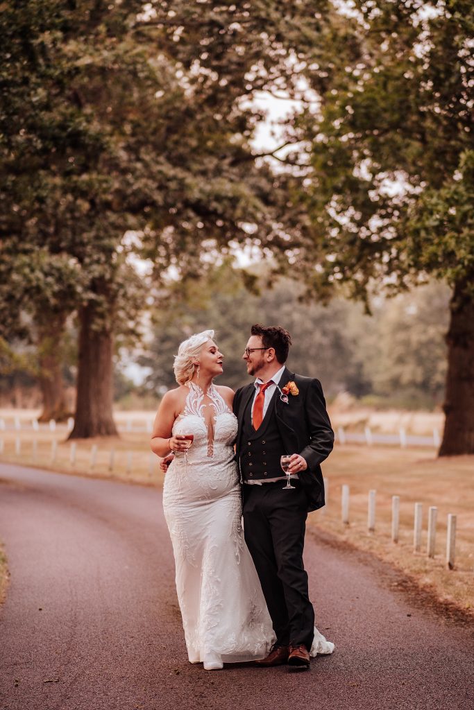 bride and groom walk down driveway at Blake Hall