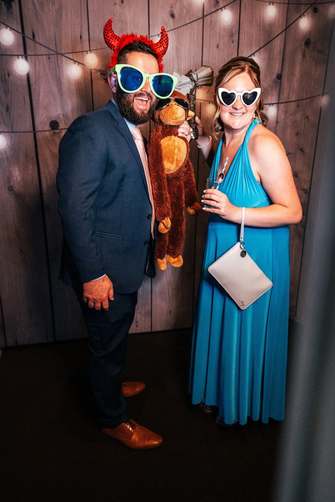 guests in photo booth with props