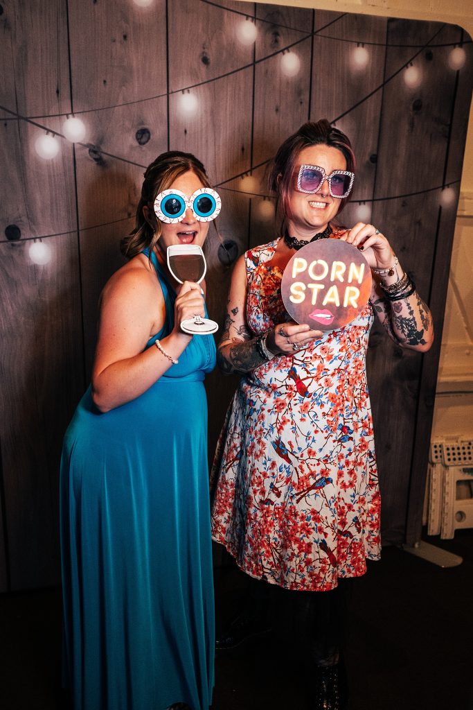 guests in props in photo booth