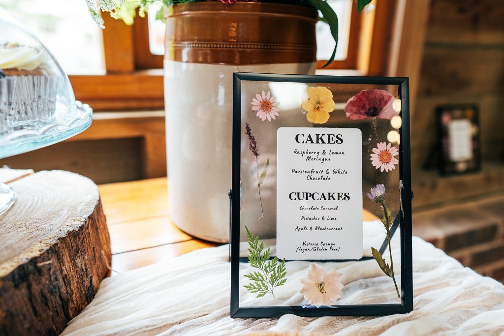 frame with pressed flowers and a cake sign for table