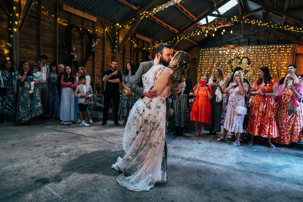 bride and groom kiss on dance floor