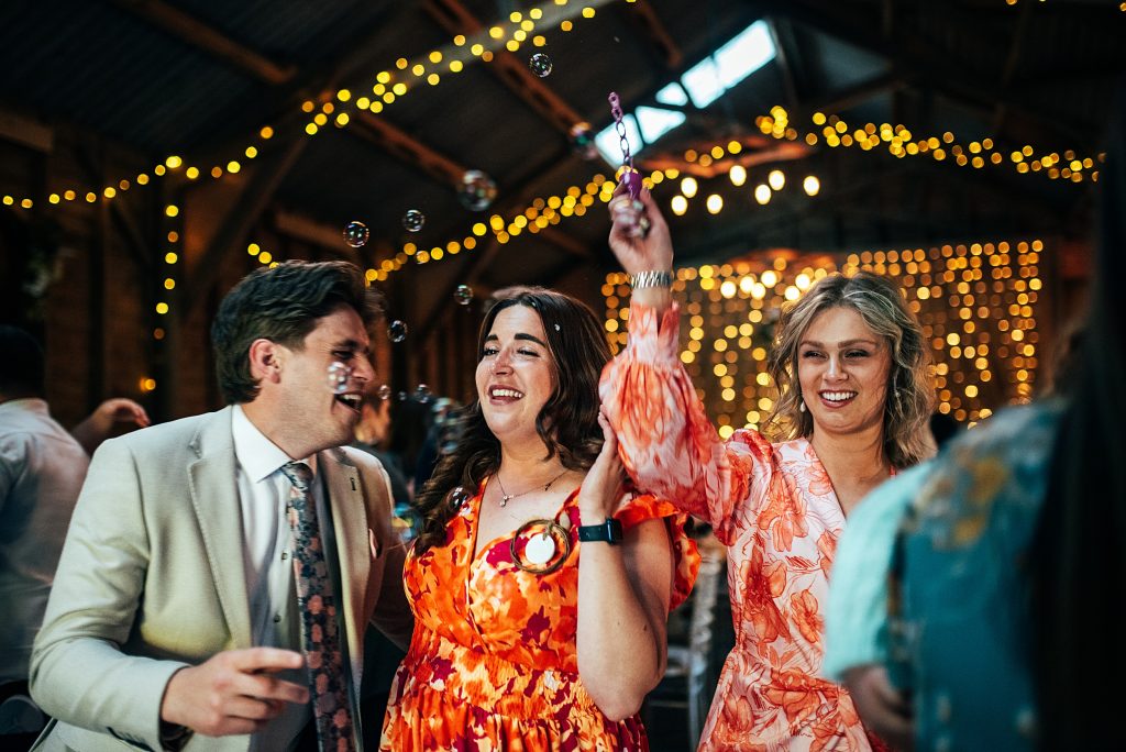 wedding guests on dance floor with bubbles