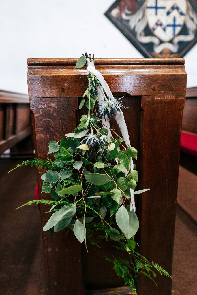 hand tied wild flowers on church pew
