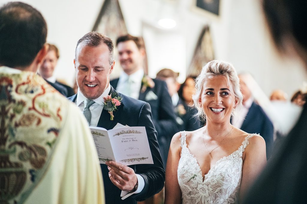 bride and groom sign hymns in church