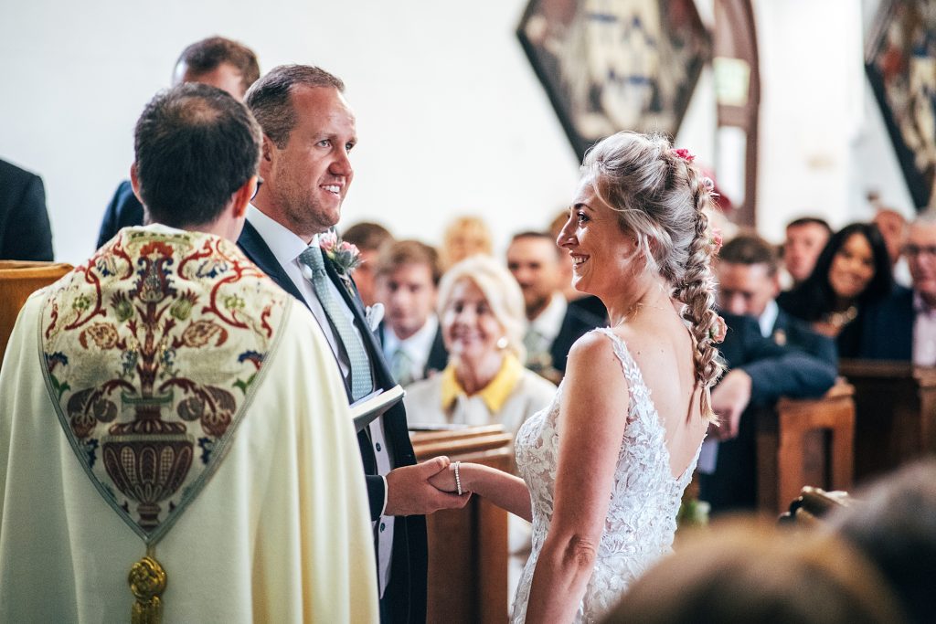 smiling bride and groom ceremony in church
