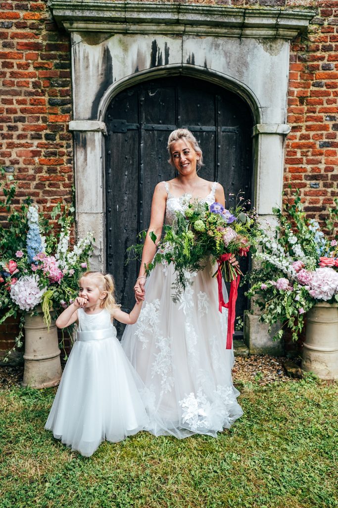 bride with daughter in church doorway