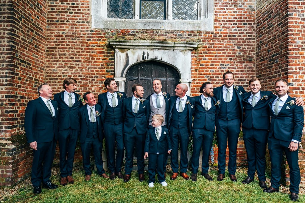 groom with groomsmen outside church