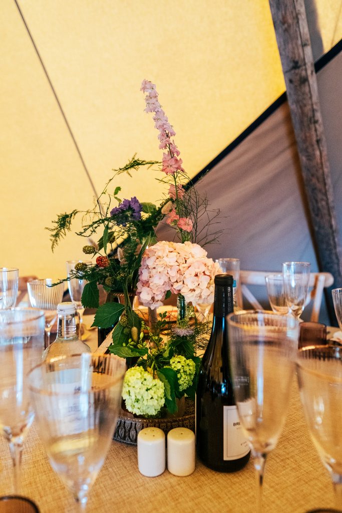wild flowers on wedding table in tipi