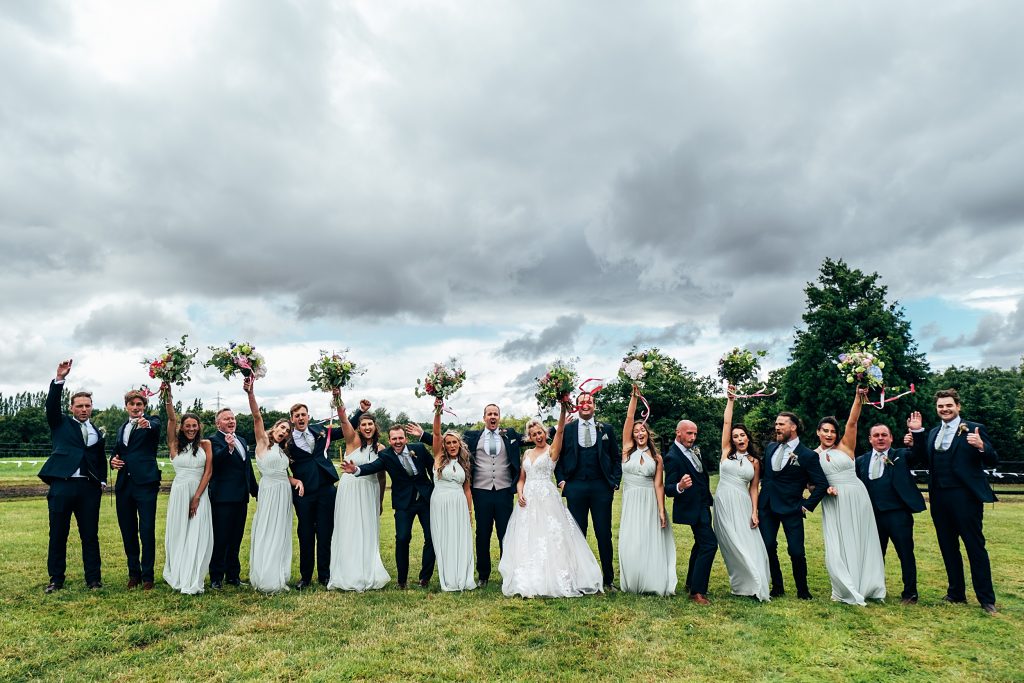 bride and groom with large wedding party