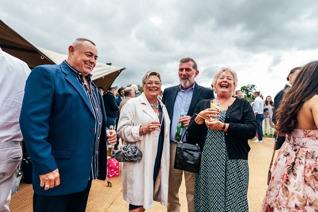 laughing wedding guests