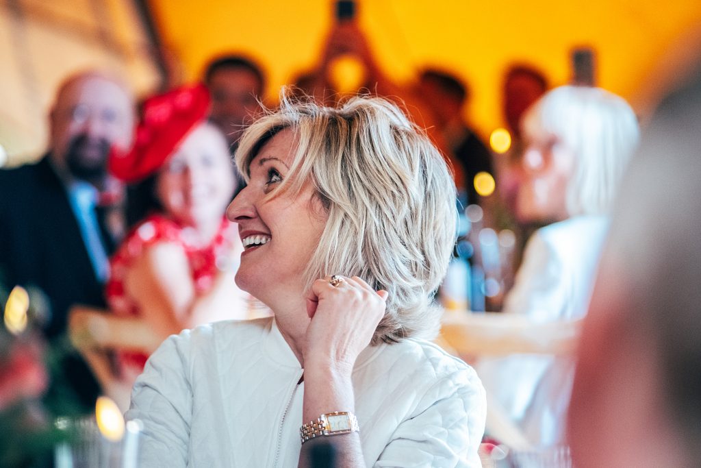 guest laughs at speeches in tipi
