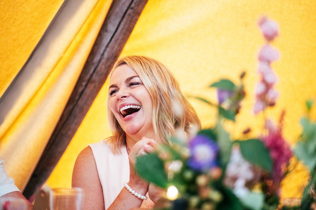 guest laughs at speeches in tipi