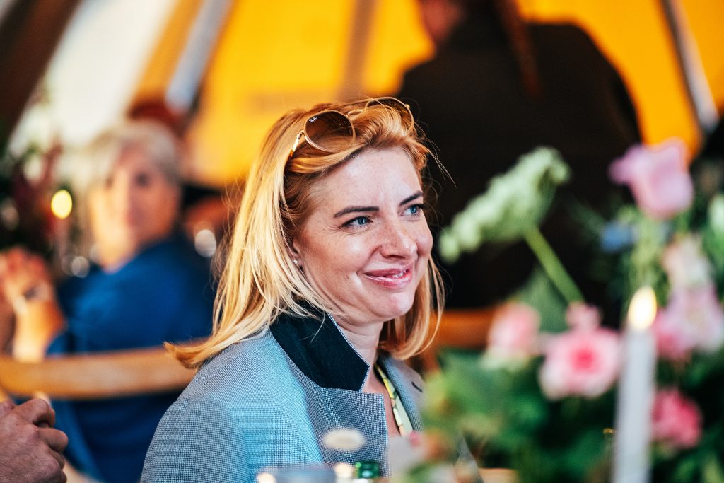 guest smiles during speeches in tipi
