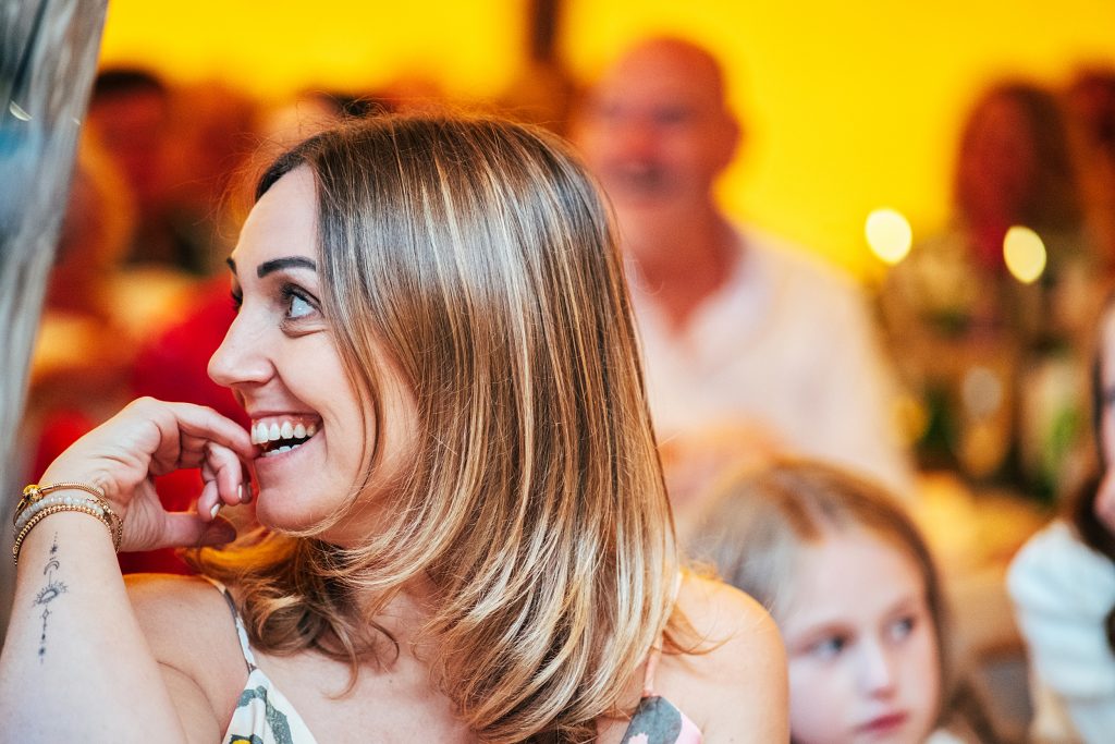 guest laughs at speeches in tipi