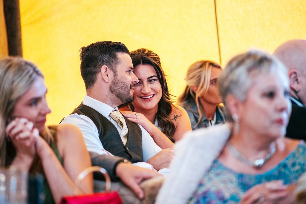 couple look at each other in a moment during speeches in tipi