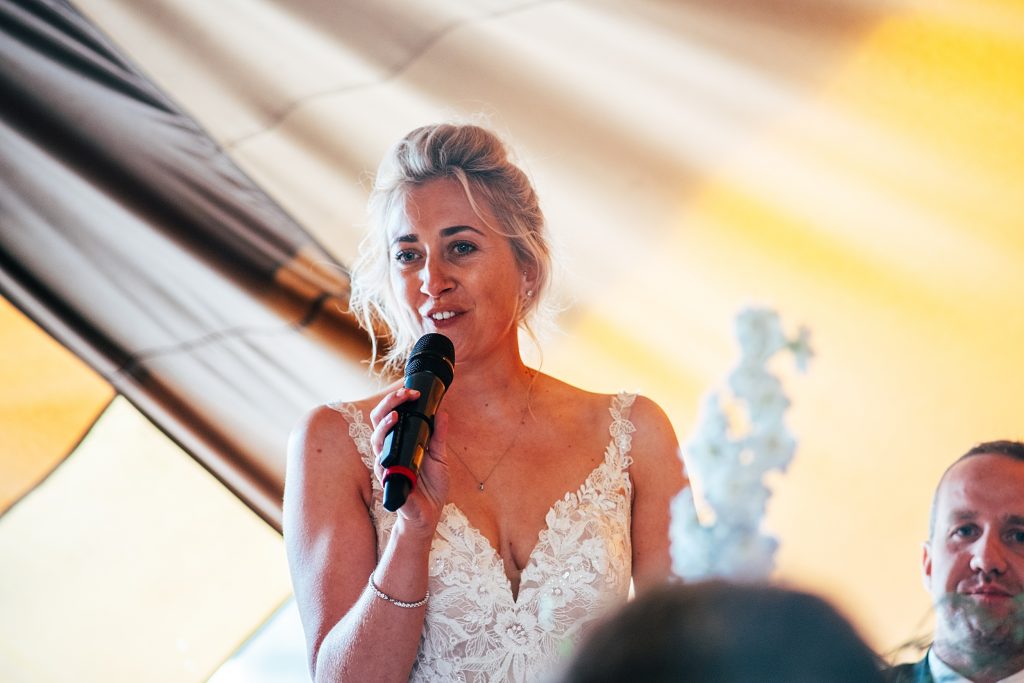 bride gives speech in tipi