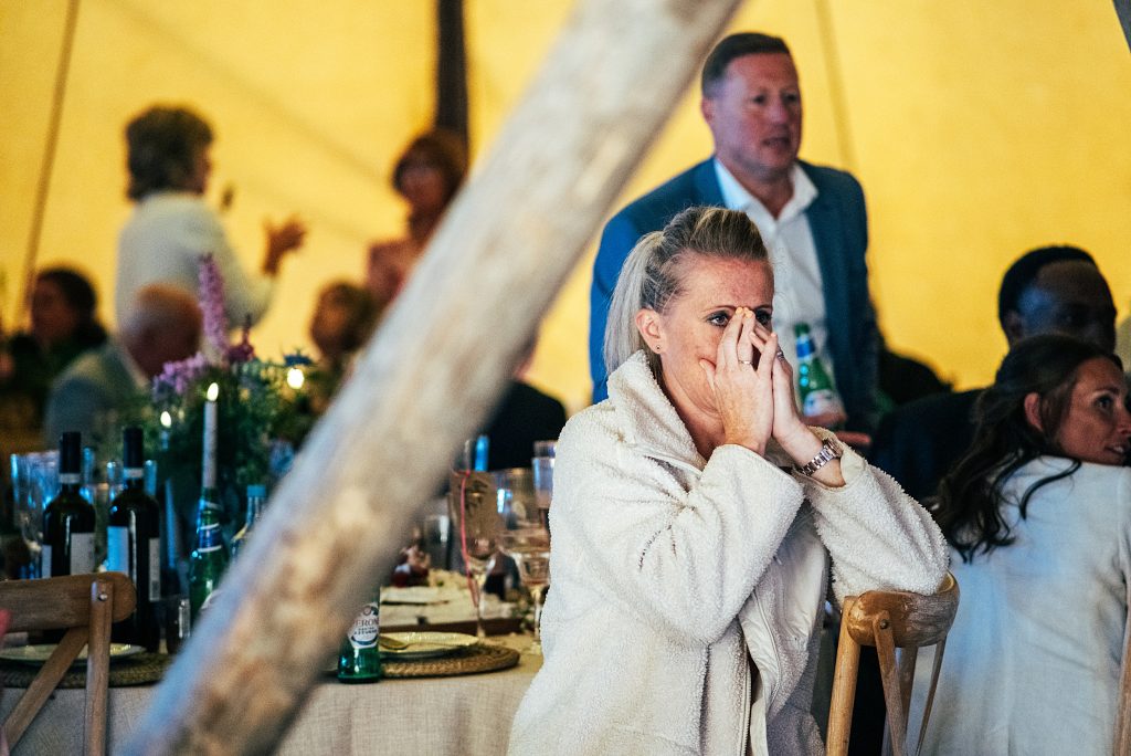 woman holds face in hands as she watches England cup final
