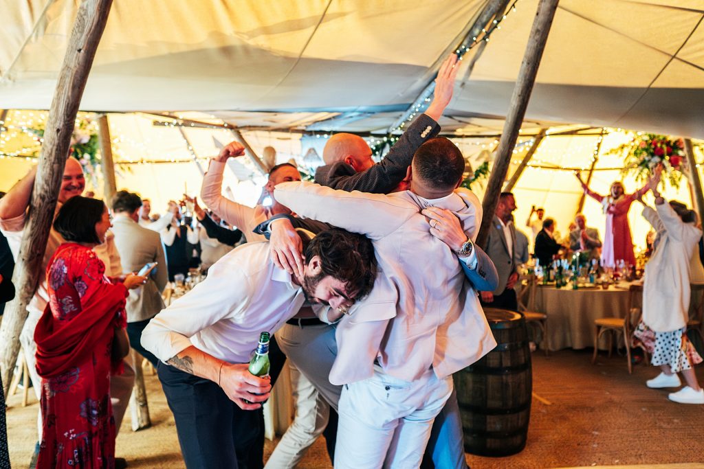 guests hug and celebrate England scoring a goal in a cup game