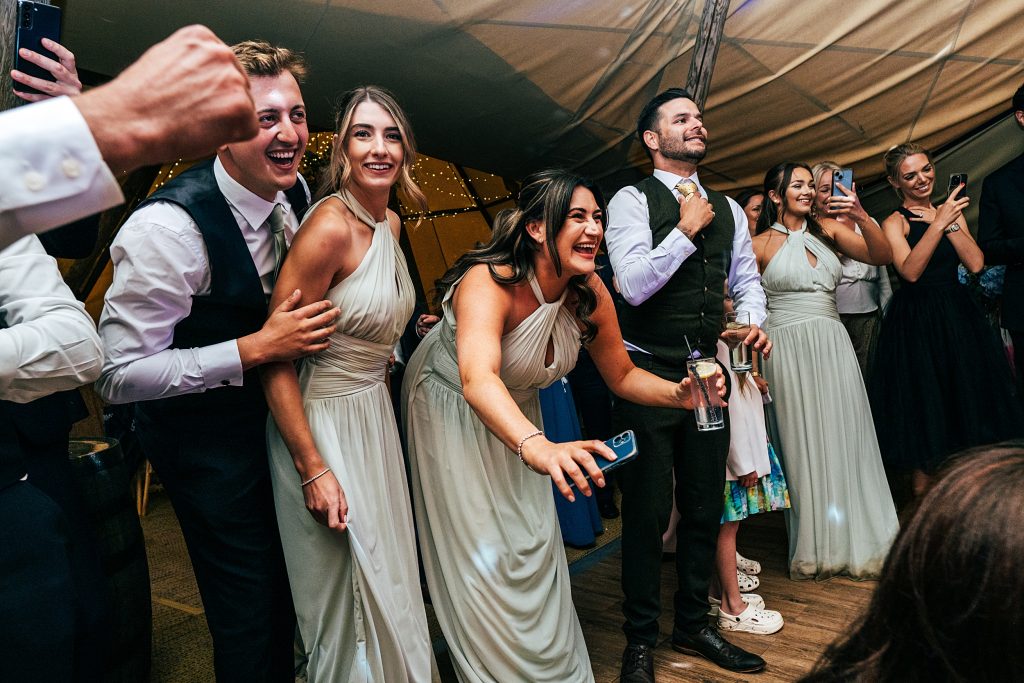 wedding guests on dance floor in a tipi