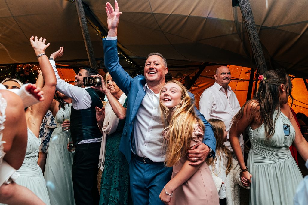 Wedding guests on dance floor in tipi