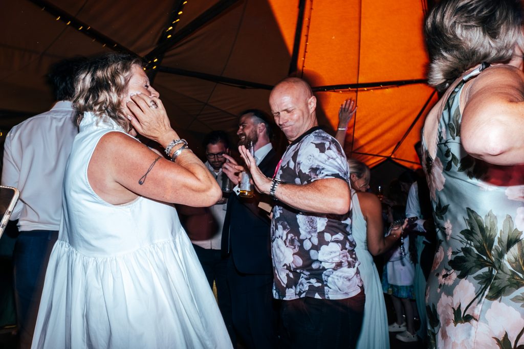 wedding guests on dance floor in tipi