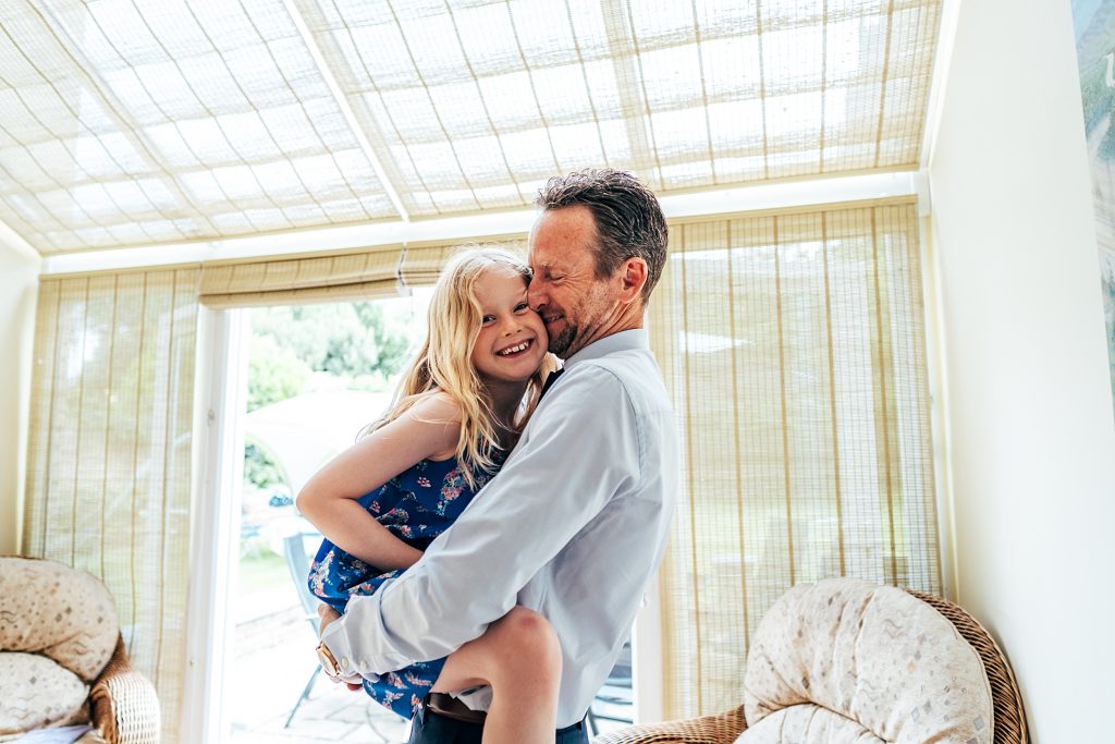 dad hugs little girl