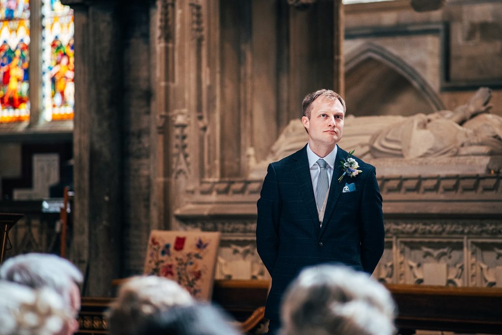 Groom waits for bride in Ely Cathedral