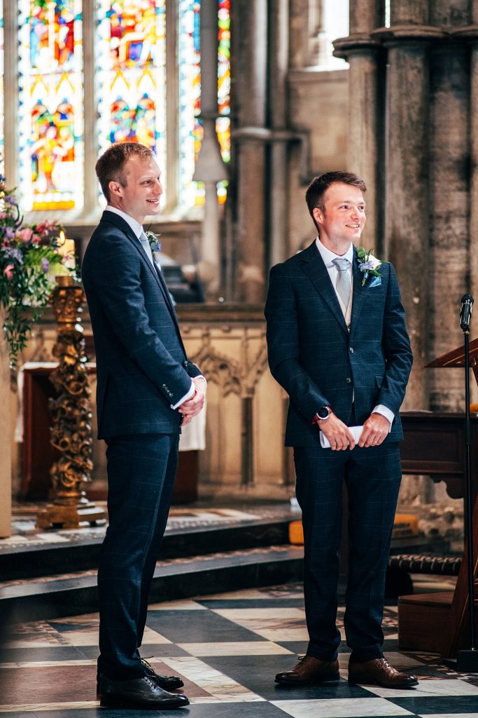 Groom and Best man wait for bride in Ely Cathedral