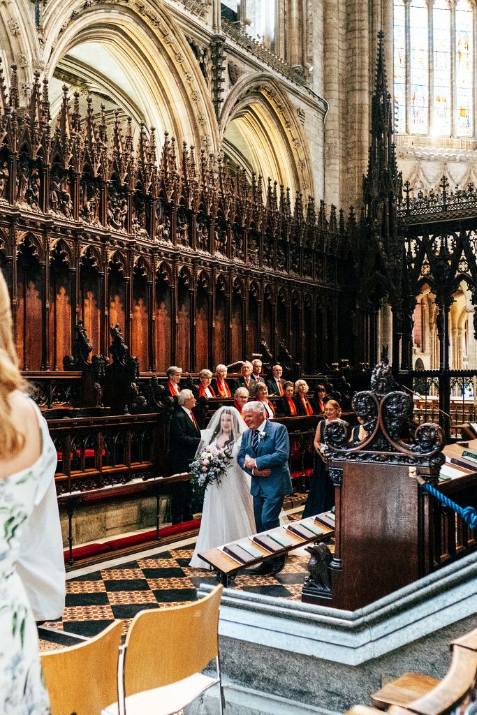 Bride walks down aisle Ely Cathedral