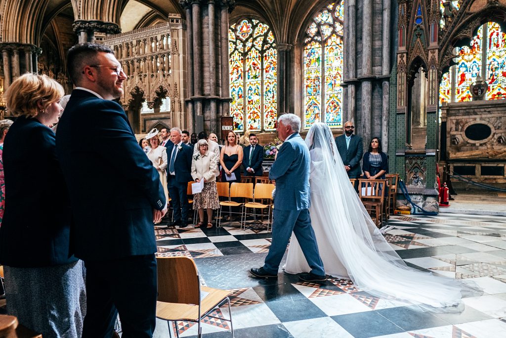 bride walks aisle with dad Ely Cathedral