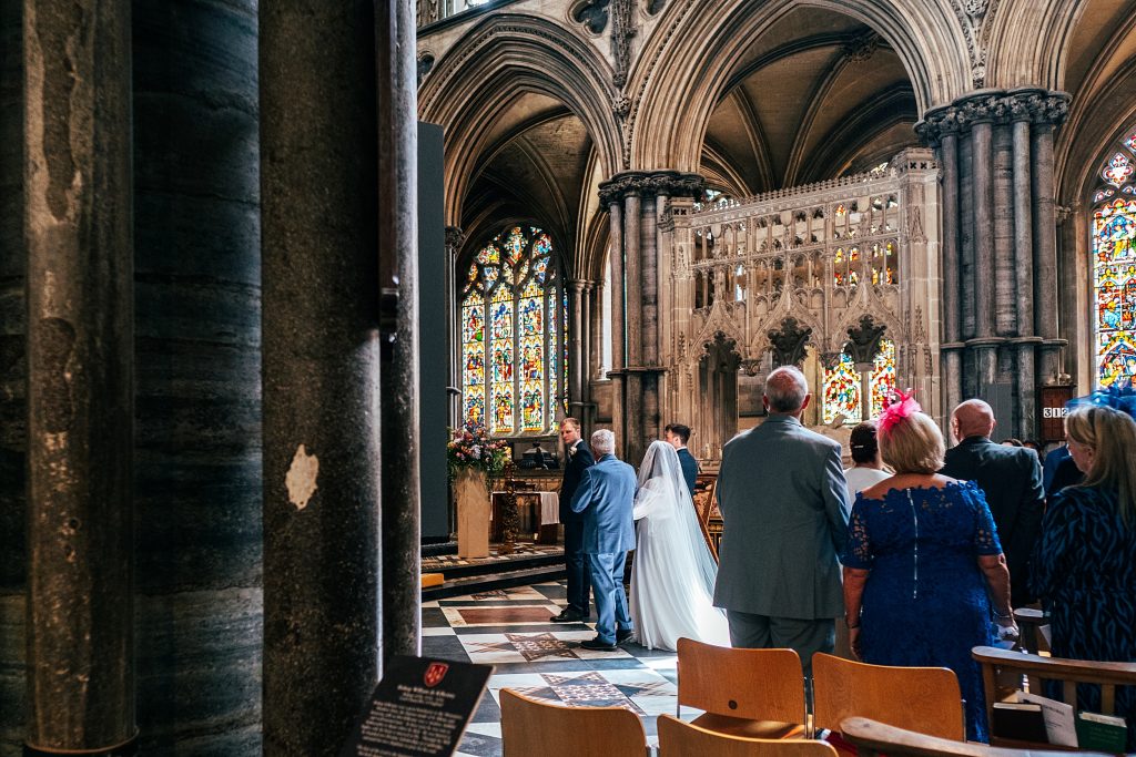 Bride meets groom at top of aisle at Ely Cathedral