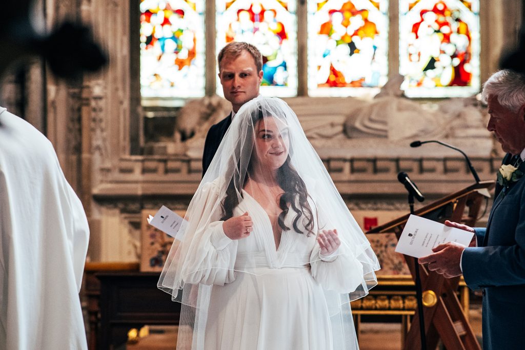 Bride lifts veil Ely Cathedral