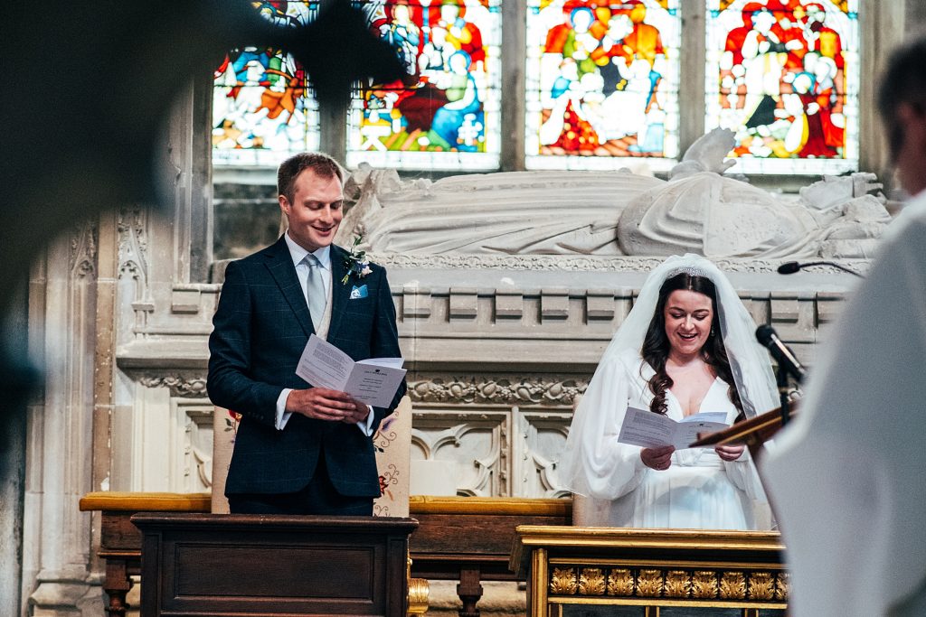 bride and groom laugh during a hymn