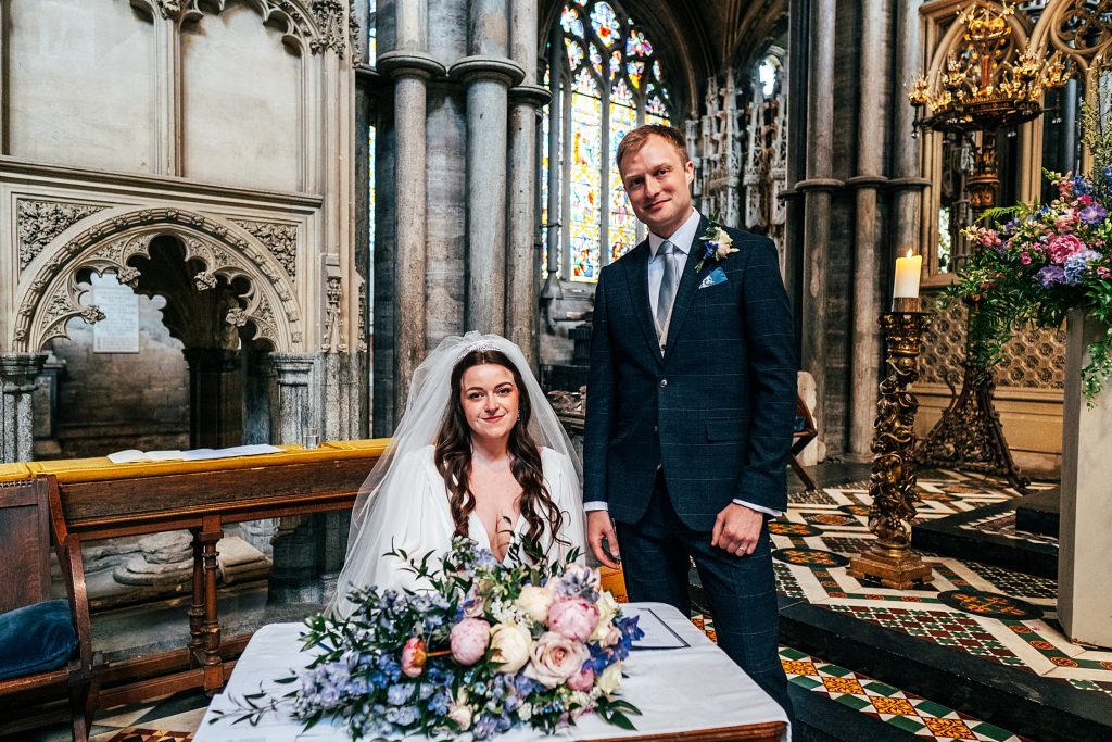 bride and groom sign register Ely cathedral