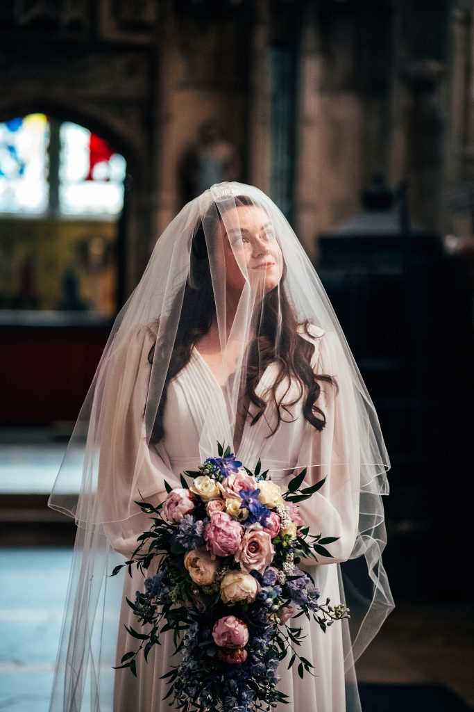 bride under veil in Ely Cathedral