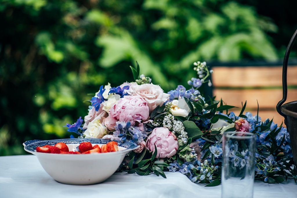 discarded bouquet next to bowl of strawberries