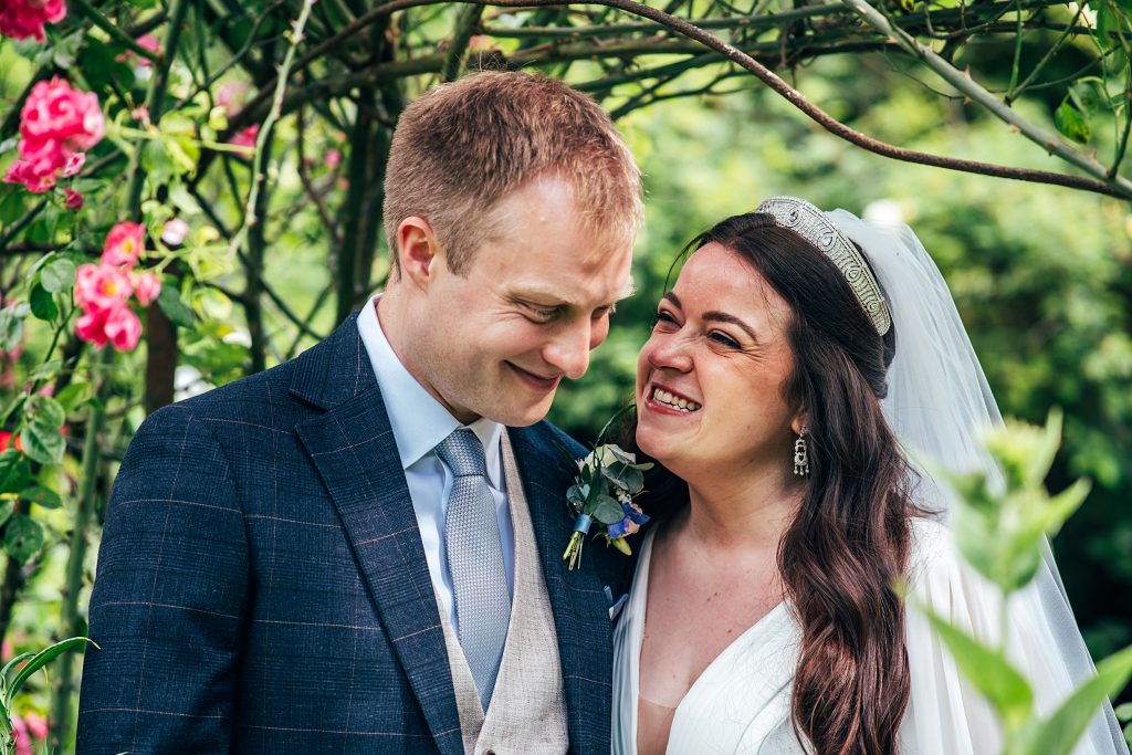 laughing bride and groom in garden